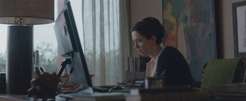 Movie still from “The Gift” (2015), directed by Joel Edgerton – A woman sitting in front of a computer monitor; Medium shot, High angle