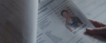 Movie still from “The Gift” (2015), directed by Joel Edgerton – A police department arrest report; Extreme Close Up shot, Overhead angle