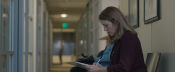 Movie still from “The Gift” (2015), directed by Joel Edgerton – A woman writing on a piece of paper in a library; Medium shot, Over the shoulder angle