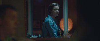 Movie still from “The Gift” (2015), directed by Joel Edgerton – A woman standing in front of a window at night; Medium shot, Over the shoulder angle