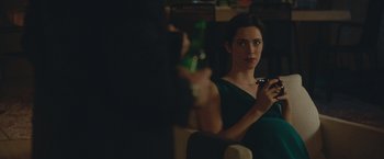 Movie still from “The Gift” (2015), directed by Joel Edgerton – A woman is holding a glass of beer in front of a mirror; Medium shot, Over the shoulder angle