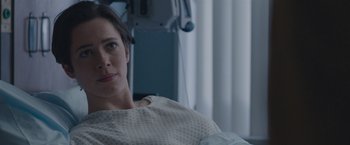 Movie still from “The Gift” (2015), directed by Joel Edgerton – A woman sitting in a hospital bed looking at the camera; Close Up shot, Over the shoulder angle