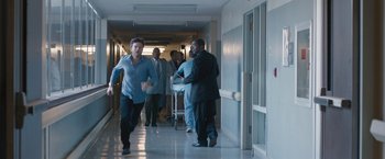 Movie still from “The Gift” (2015), directed by Joel Edgerton – A group of people in a hospital hallway; Wide shot, Over the shoulder angle