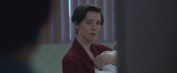 Movie still from “The Gift” (2015), directed by Joel Edgerton – A woman in a red shirt is holding a baby in her arms; Close Up shot, Over the shoulder angle
