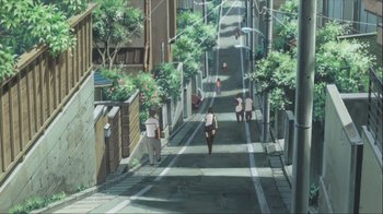 Movie still from “The Girl Who Leapt Through Time” (2006), directed by Mamoru Hosoda – People walking down a street with trees in the background; Extreme Wide shot, High angle