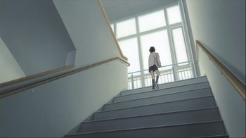 Movie still from “The Girl Who Leapt Through Time” (2006), directed by Mamoru Hosoda – A woman walking up a flight of stairs in front of a large window; Wide shot, Low angle