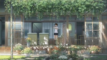 Movie still from “The Girl Who Leapt Through Time” (2006), directed by Mamoru Hosoda – An animated scene of a woman standing on the porch of a house; Extreme Wide shot, Low angle
