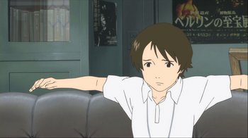 Movie still from “The Girl Who Leapt Through Time” (2006), directed by Mamoru Hosoda – A young boy sitting on a couch in front of a window; Medium shot, High angle