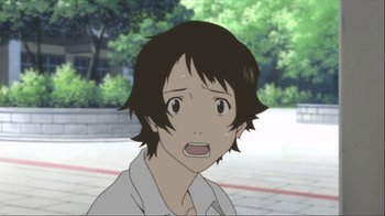 Movie still from “The Girl Who Leapt Through Time” (2006), directed by Mamoru Hosoda – A young man with short hair is looking surprised; Close Up shot, High angle
