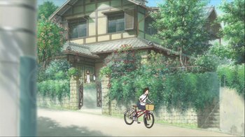 Movie still from “The Girl Who Leapt Through Time” (2006), directed by Mamoru Hosoda – A woman riding a bike down a street; Extreme Wide shot, High angle
