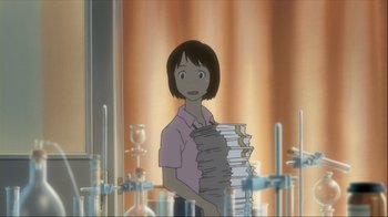 Movie still from “The Girl Who Leapt Through Time” (2006), directed by Mamoru Hosoda – A woman standing in front of a stack of papers; Medium shot, Over the shoulder angle