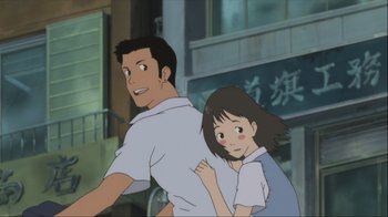 Movie still from “The Girl Who Leapt Through Time” (2006), directed by Mamoru Hosoda – A man and a girl are standing in front of a building; Medium shot, Low angle
