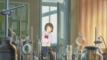 Movie still from “The Girl Who Leapt Through Time” (2006), directed by Mamoru Hosoda – A girl standing in front of a window in a room filled with glassware; Wide shot, Over the shoulder angle