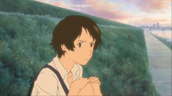 Movie still from “The Girl Who Leapt Through Time” (2006), directed by Mamoru Hosoda – A young man standing in front of a grassy hill; Close Up shot, High angle