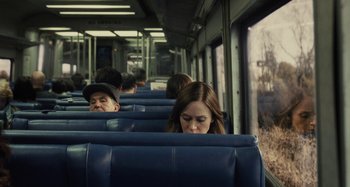 Movie still from “The Girl on the Train” (2016), directed by Tate Taylor – A woman sitting on a train with her eyes closed; Medium shot, Over the shoulder angle