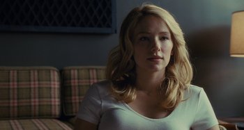 Movie still from “The Girl on the Train” (2016), directed by Tate Taylor – A beautiful blonde woman sitting on a couch in front of a window; Close Up shot, Over the shoulder angle