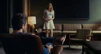 Movie still from “The Girl on the Train” (2016), directed by Tate Taylor – A woman in a white dress standing in front of a man; Wide shot, Over the shoulder angle