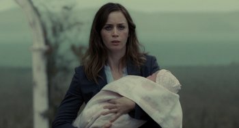 Movie still from “The Girl on the Train” (2016), directed by Tate Taylor – A woman holding a baby in her arms; Close Up shot, Over the shoulder angle