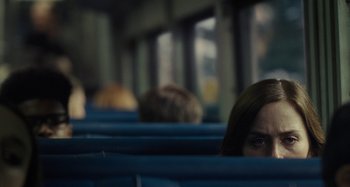 Movie still from “The Girl on the Train” (2016), directed by Tate Taylor – A woman sitting on a bus looking out the window; Medium shot, Over the shoulder angle