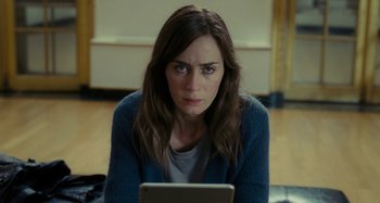 Movie still from “The Girl on the Train” (2016), directed by Tate Taylor – A woman sitting on the ground looking at a laptop; Close Up shot, Over the shoulder angle