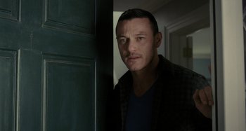 Movie still from “The Girl on the Train” (2016), directed by Tate Taylor – A person standing in front of a door; Close Up shot, Over the shoulder angle