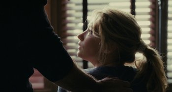 Movie still from “The Girl on the Train” (2016), directed by Tate Taylor – A woman looking out a window with a hand on her shoulder; Close Up shot, Over the shoulder angle