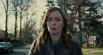 Movie still from “The Girl on the Train” (2016), directed by Tate Taylor – A person wearing a coat near a road; Close Up shot, Over the shoulder angle