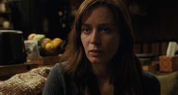 Movie still from “The Girl on the Train” (2016), directed by Tate Taylor – A person sitting on a couch; Close Up shot, Over the shoulder angle