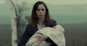 Movie still from “The Girl on the Train” (2016), directed by Tate Taylor – A woman holding a baby in her arms; Close Up shot, Over the shoulder angle