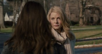 Movie still from “The Girl on the Train” (2016), directed by Tate Taylor – A woman with long blonde hair wearing a white scarf; Close Up shot, Over the shoulder angle
