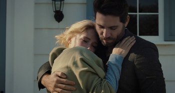 Movie still from “The Girl on the Train” (2016), directed by Tate Taylor – A man and a woman hugging outside of a house; Close Up shot, Over the shoulder angle