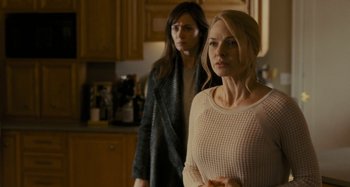 Movie still from “The Girl on the Train” (2016), directed by Tate Taylor – Two women standing in a kitchen next to each other; Medium shot, Over the shoulder angle