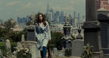 Movie still from “The Girl on the Train” (2016), directed by Tate Taylor – A woman in a blue coat walking through a cemetery; Wide shot, Over the shoulder angle