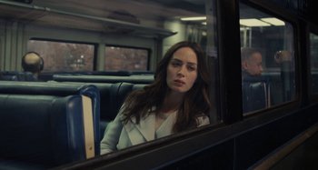 Movie still from “The Girl on the Train” (2016), directed by Tate Taylor – A woman sitting on a train looking out of the window; Medium shot, Over the shoulder angle