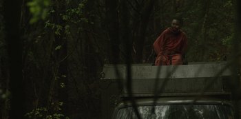 Movie still from “The Girl with All the Gifts” (2016), directed by Colm McCarthy – A man sitting on top of a truck in the middle of a forest; Wide shot, Low angle