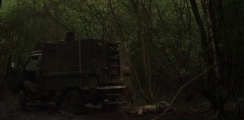 Movie still from “The Girl with All the Gifts” (2016), directed by Colm McCarthy – A truck is parked in the middle of the woods; Wide shot, Low angle