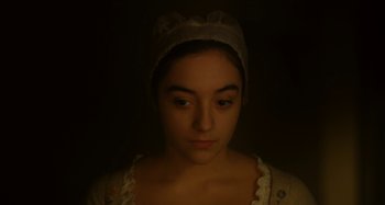 Movie still from “Portrait of a Lady on Fire” (2019), directed by Céline Sciamma – A young woman wearing a white hat and a white dress; Close Up shot, High angle