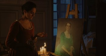 Movie still from “Portrait of a Lady on Fire” (2019), directed by Céline Sciamma – A woman standing in front of a painting of a woman; Medium shot, Over the shoulder angle