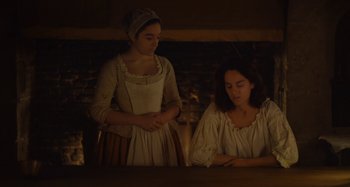 Movie still from “Portrait of a Lady on Fire” (2019), directed by Céline Sciamma – Two women in medieval clothing standing next to each other; Medium shot, Over the shoulder angle