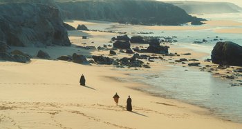 Movie still from “Portrait of a Lady on Fire” (2019), directed by Céline Sciamma – Two people walking on the beach near the water; Extreme Wide shot, High angle