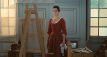 Movie still from “Portrait of a Lady on Fire” (2019), directed by Céline Sciamma – A woman in a red dress standing in front of an easel; Medium shot, Low angle