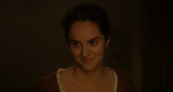 Movie still from “Portrait of a Lady on Fire” (2019), directed by Céline Sciamma – A person smiling for the camera; Close Up shot, Over the shoulder angle
