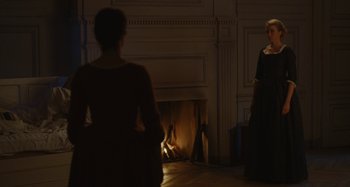 Movie still from “Portrait of a Lady on Fire” (2019), directed by Céline Sciamma – Two women standing in front of a fire place; Wide shot, Over the shoulder angle