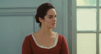 Movie still from “Portrait of a Lady on Fire” (2019), directed by Céline Sciamma – A woman in a red dress looking to her left; Close Up shot, Over the shoulder angle