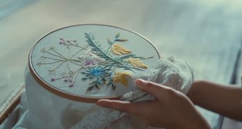 Movie still from “Portrait of a Lady on Fire” (2019), directed by Céline Sciamma – A person is working on an embroidery project; Extreme Close Up shot, High angle