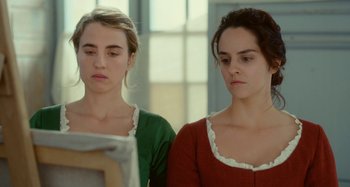 Movie still from “Portrait of a Lady on Fire” (2019), directed by Céline Sciamma – Two young women are looking at a piece of paper; Close Up shot, Over the shoulder angle