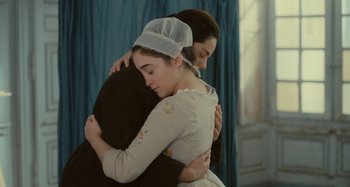 Movie still from “Portrait of a Lady on Fire” (2019), directed by Céline Sciamma – Two women are embracing each other in a room; Medium shot, Over the shoulder angle