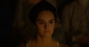 Movie still from “Portrait of a Lady on Fire” (2019), directed by Céline Sciamma – A young woman with dark hair is looking at the camera; Close Up shot, Over the shoulder angle