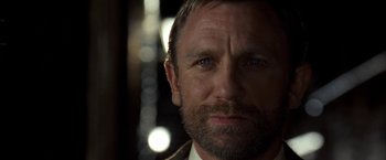 Movie still from “The Golden Compass” (2007), directed by Chris Weitz – A person wearing a suit and tie; Close Up shot, Over the shoulder angle