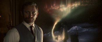 Movie still from “The Golden Compass” (2007), directed by Chris Weitz – A man standing in front of an image of an aurora borealis; Close Up shot, Over the shoulder angle